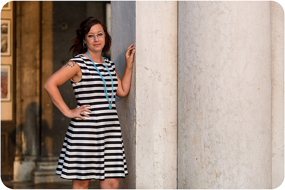 Portrait of the mother standing by Venetian columns, showcasing her elegant style.
