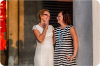 Mother and daughter sharing a playful moment by the Venetian columns during their photoshoot.