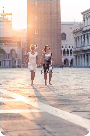 Mother and daughter hugging in St. Mark's Square during their early morning photoshoot.