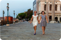 Mother and daughter walking through the quiet streets of Venice at sunrise.