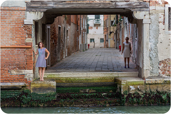 Mother and daughter exploring the quiet, narrow streets of Venice during their family photoshoot.