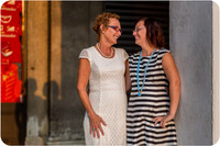 Mother and daughter sharing a candid moment, laughing together in Venice.