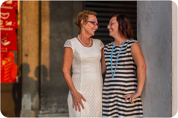 Mother and daughter sharing a candid moment, laughing together in Venice.