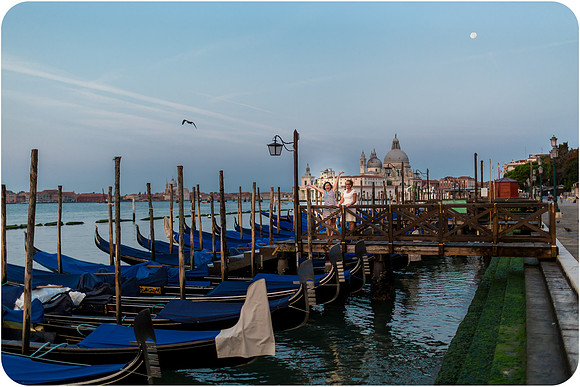 Gondolas on the water at sunrise in Venice, capturing the serene morning atmosphere.