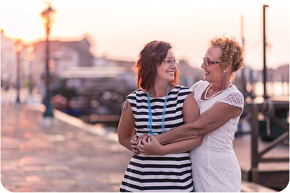 Mother and daughter walking joyfully through the streets of Venice during their sunrise photoshoot.