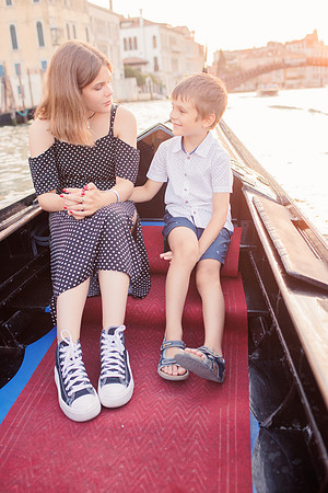 brother and sister  sharing a moment on a gondola.
