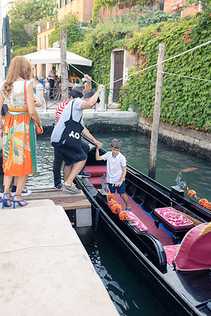 Children by a gondola in Venice.