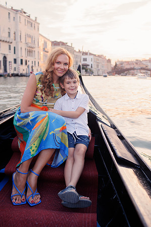 Mother and son laughing on a gondola.
