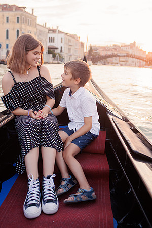 Family having fun on a gondola in Venice.