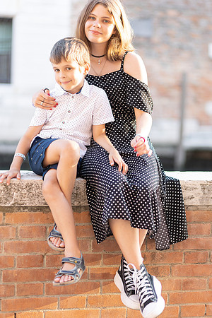 Couple sitting on a wall in Venice.
