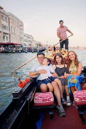 family enjoying a gondola ride in Venice.