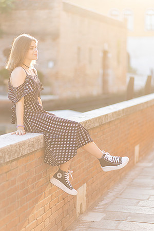 girl on a stone ledge in Venice during a family portrait session