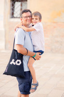 Cheerful family in colorful Venetian surroundings.