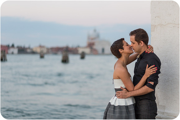 Couple embracing with early morning light behind them