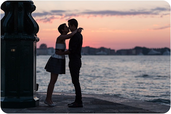Kissing in silhouette with a stunning lagoon backdrop