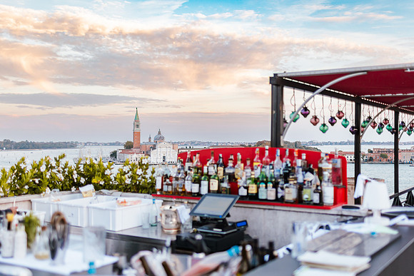 Elegant dining setup at a rooftop bar in Venice