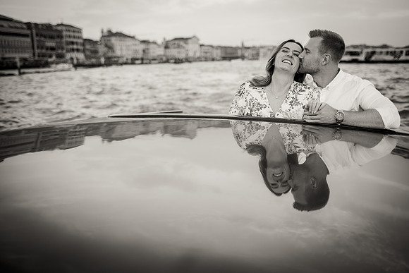 Engaged couple celebrating in rooftop pool in Venice
