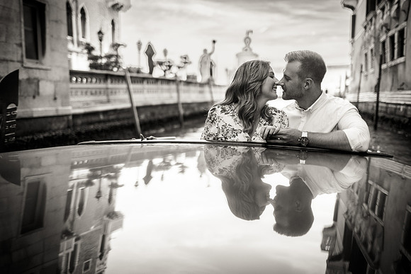 Engaged couple looking at their reflection in rooftop pool