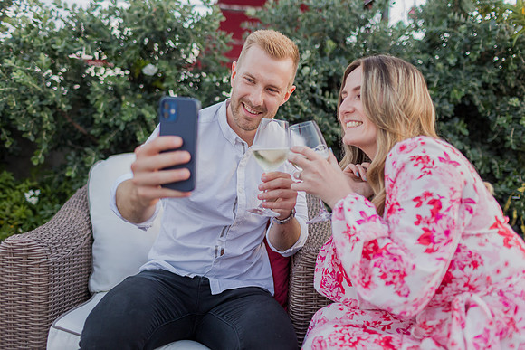 Engaged couple taking a selfie on a rooftop in Venice