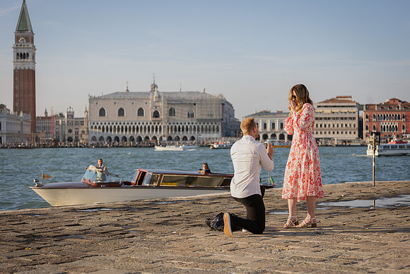 Couple embracing after proposal during sunset in Venice