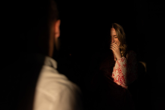 Engaged couple sharing a quiet toast on a rooftop