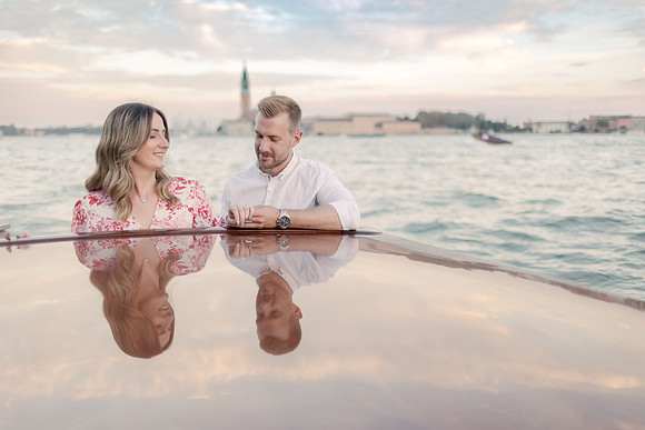 Engaged couple’s reflection in rooftop water