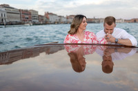 Engaged couple sharing a soft embrace in Venice