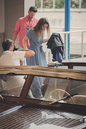 Couple stepping onto a dock in Venice, ready to board a water taxi.