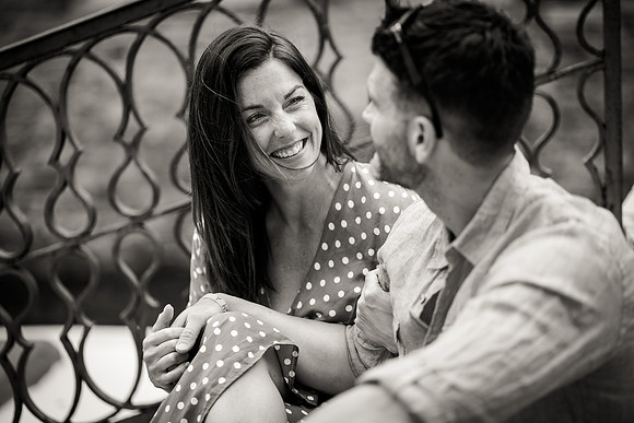 Couple smiling and laughing on a romantic bridge in Venice.