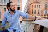 Casual portrait on boat with Venetian architecture in background