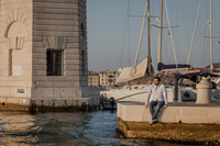 Man walking through Venice with sunset behind