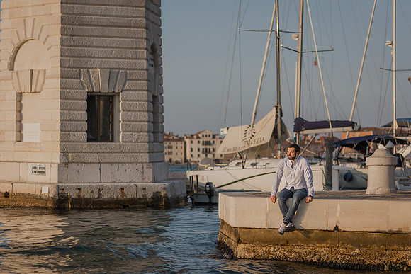 Man walking through Venice with sunset behind