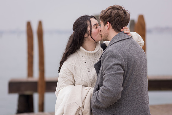 Romantic kiss after proposal in Venice during winter