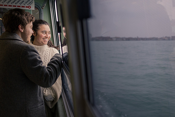 Couple on ferry ride after proposal in Venice