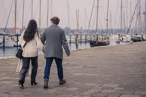 Engaged couple walking hand-in-hand after proposal in Venice