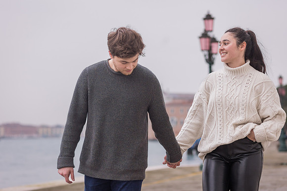 Hand-in-hand walk along Venice waterfront