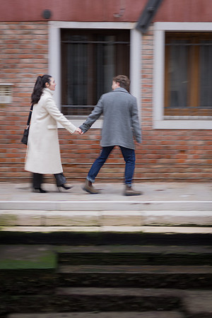 Hand-in-hand walk along quiet street in Venice