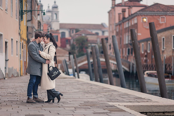 Romantic embrace by Venice canal in winter