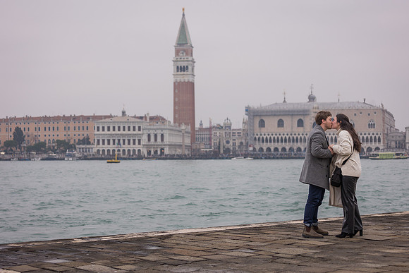 Couple celebrating engagement by San Giorgio Maggiore