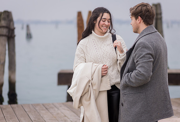 Laughing couple after proposal in Venice winter setting