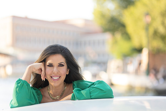 Candid portrait, water taxi, Venice canals, smiling woman.