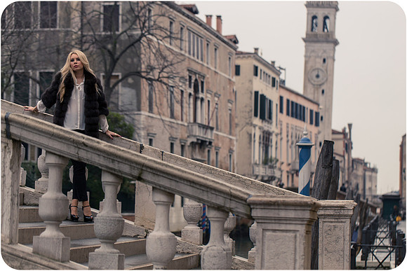 Elegant portrait on Venetian stairway in winter