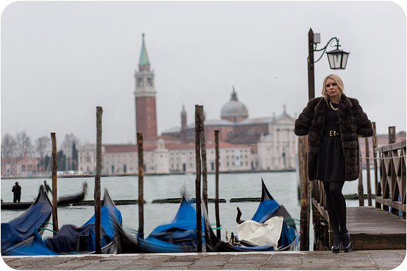 Contemplative pose by Venetian canal in winter