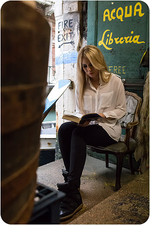 Woman reading in a Venetian bookshop - cozy winter scene