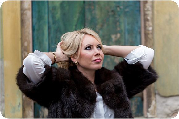 Elegant woman posing by Venetian wall in winter