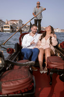 Violinist playing for couple on a gondola in Venice