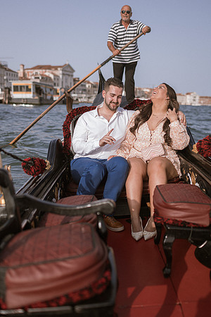 Violinist playing for couple on a gondola in Venice