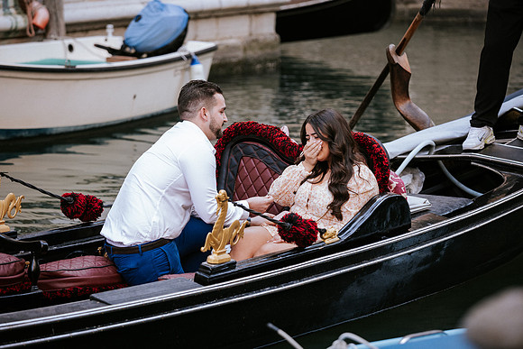 Couple kissing on gondola after engagement