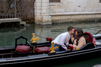 Couple in gondola with Venice canal in background