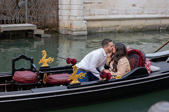 Engaged couple walking in a Venetian alley